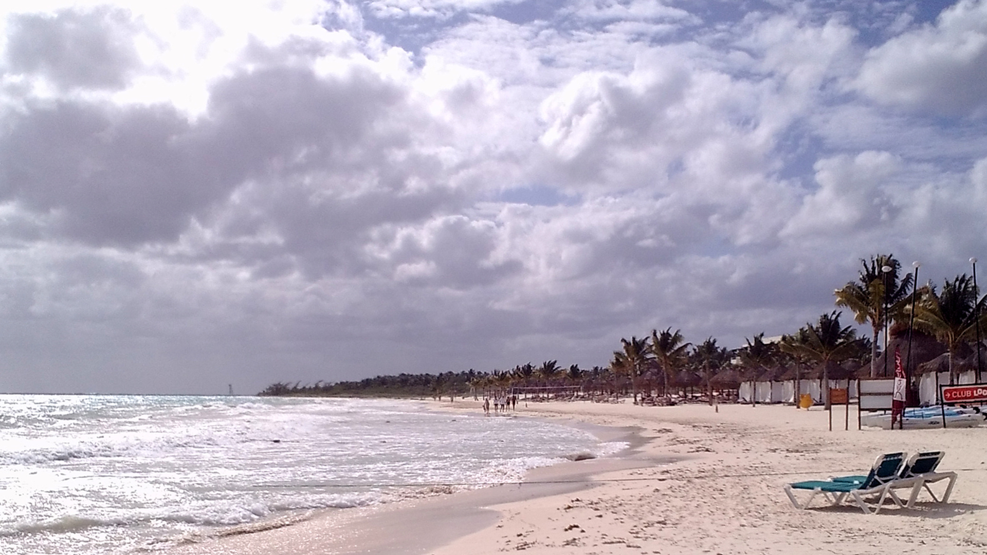 Florida Gulf Coast weather showing sunny winter beach and summer storm clouds